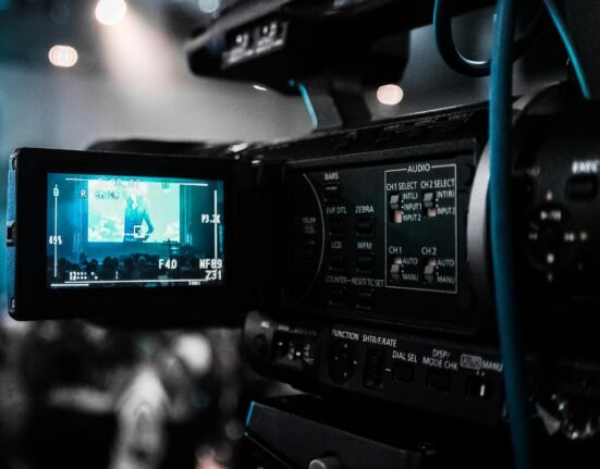 A creative professional editing a video timeline using AI-powered video editing software with automated effects and transitions